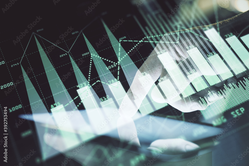 Double exposure of man's hands holding and using a digital device and forex graph drawing. Financial market concept. Double exposure of man's hands holding and using a digital device and forex graph drawing. Financial market concept.