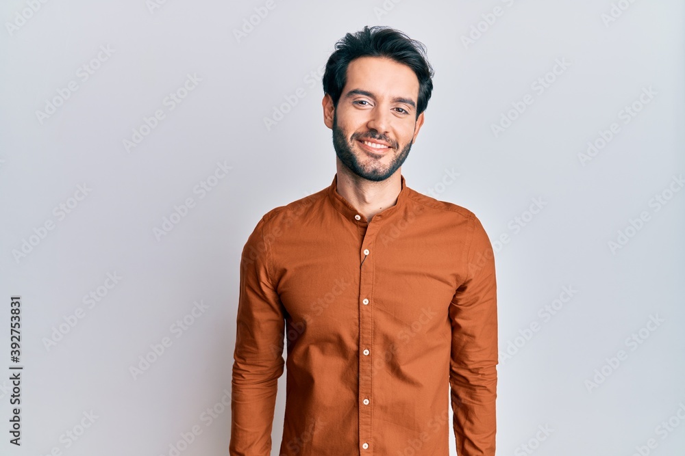 Young hispanic man wearing casual clothes with a happy and cool smile on face. lucky person. Young hispanic man wearing casual clothes with a happy and cool smile on face. lucky person.