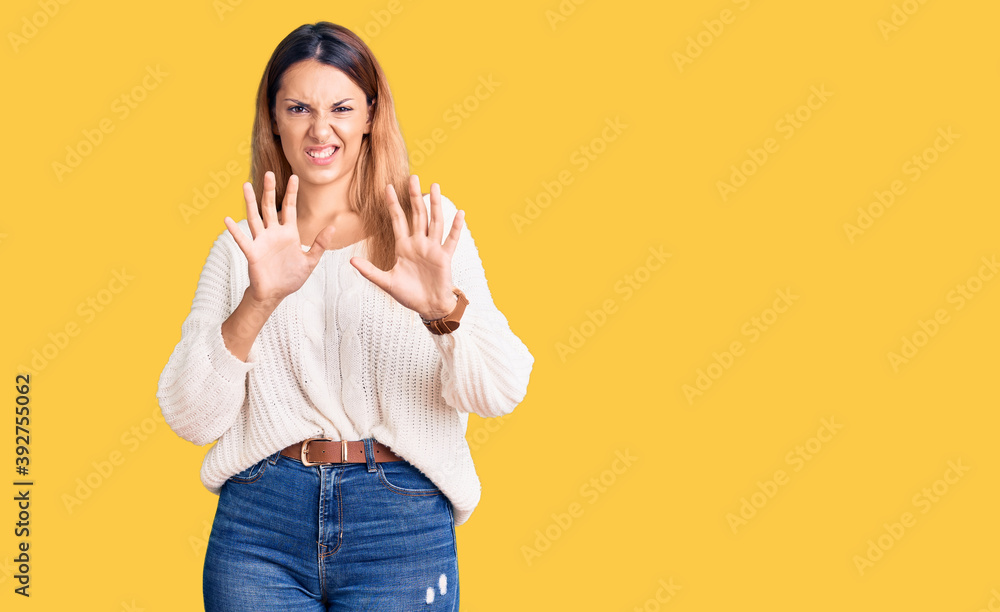 Beautiful young woman wearing casual clothes disgusted expression, displeased and fearful doing disgust face because aversion reaction. with hands raised Beautiful young woman wearing casual clothes disgusted expression, displeased and fearful doing disgust face because aversion reaction. with hands raised