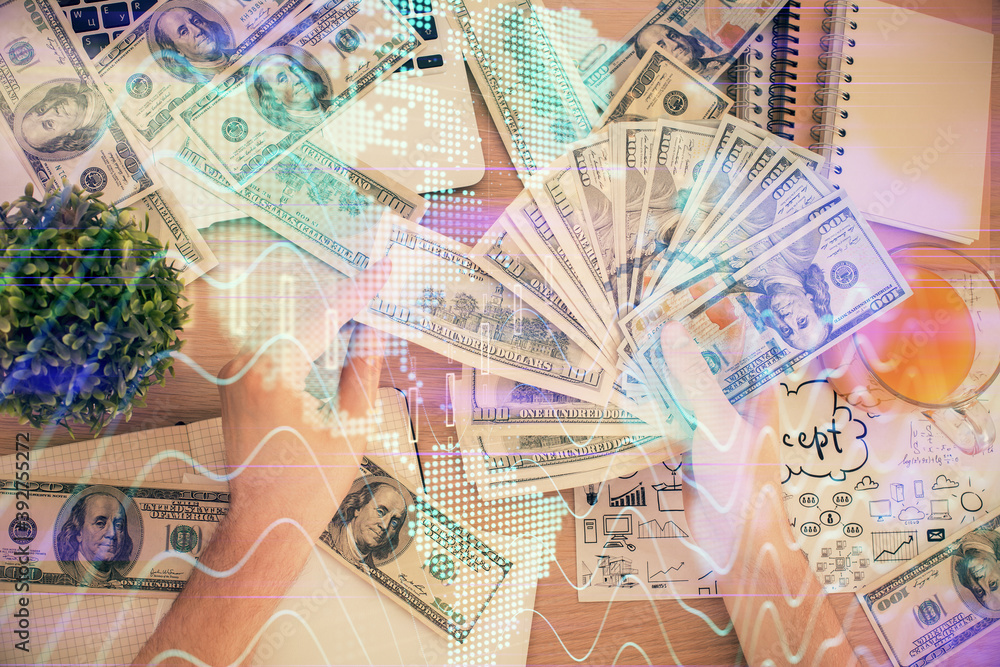 Multi exposure of financial graph drawing hologram and USA dollars bills and man hands. Analysis concept. Multi exposure of financial graph drawing hologram and USA dollars bills and man hands. Analysis concept.