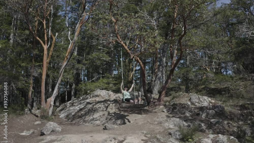 Drone Away From Woman Sitting on Tree Swing on Rocky Cliff Drone Away From Woman Sitting on Tree Swing on Rocky Cliff