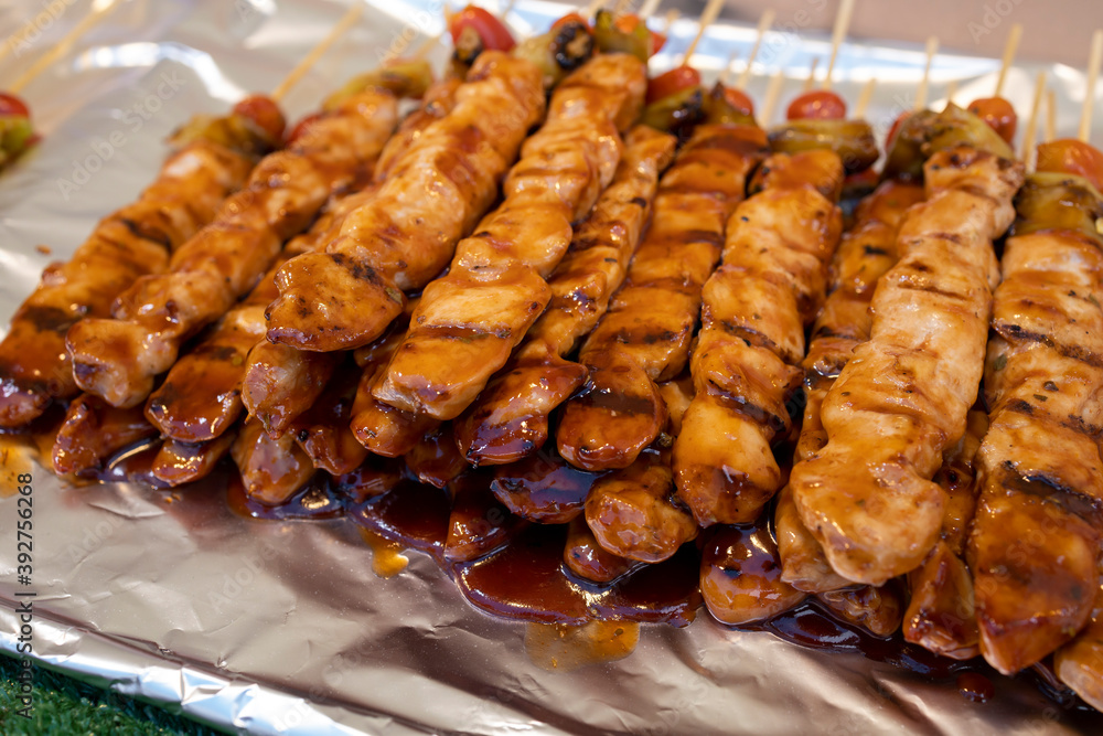 Grilled and marinated chicken skewers with chili and tomato, Thai street food