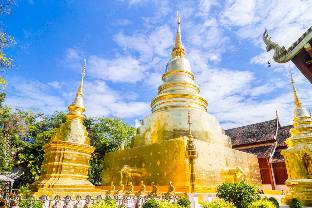 Naklejka premium Beautiful golden pagoda with blue sky at Wat Phra Singh, Thailand.