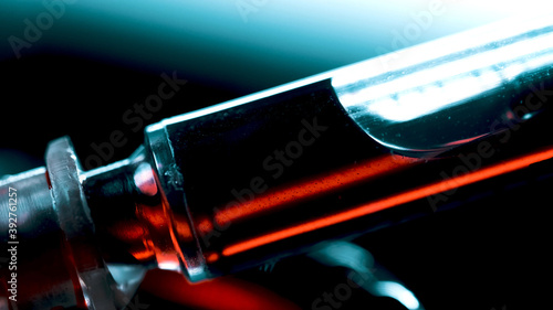 A surgical syringe injects the virus. Infected blood. Macro frame