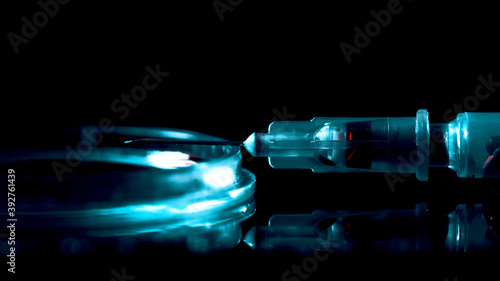 The syringe is on the table. The lighting is moving. Drugs through the needle