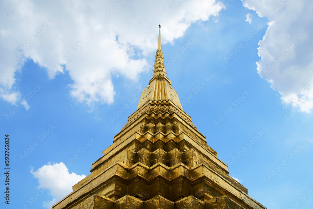 thai golden pagoda against blue sky