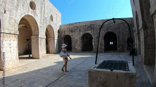 Woman sightseeing Fort Lovrijenac in Dubrovnik, Croatia 