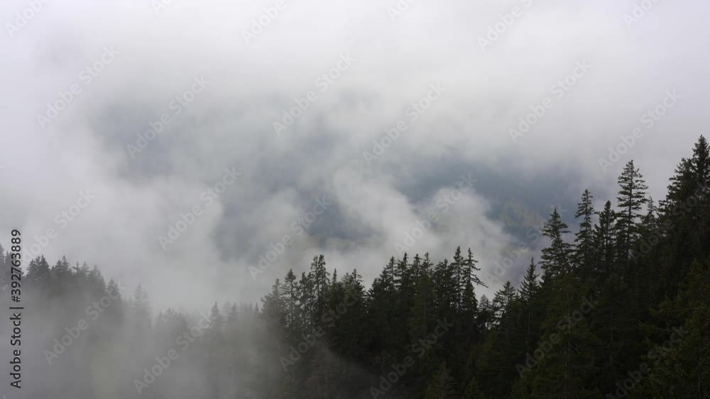 Slow moving cloud vapor obscures the mountains in this valley in the alps. Ehrwald, Lermoos, Tirol, Austria Slow moving cloud vapor obscures the mountains in this valley in the alps. Ehrwald, Lermoos, Tirol, Austria