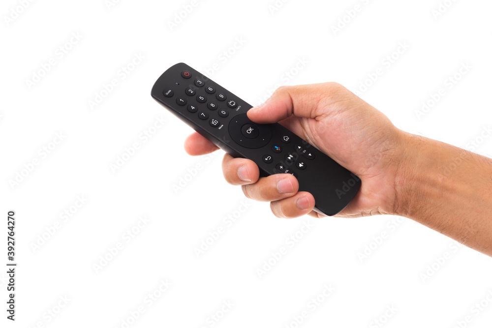 Hand holding television and audio remote control panel, studio shot isolated on over white background, Television wall broadcasting concept Hand holding television and audio remote control panel, studio shot isolated on over white background, Television wall broadcasting concept