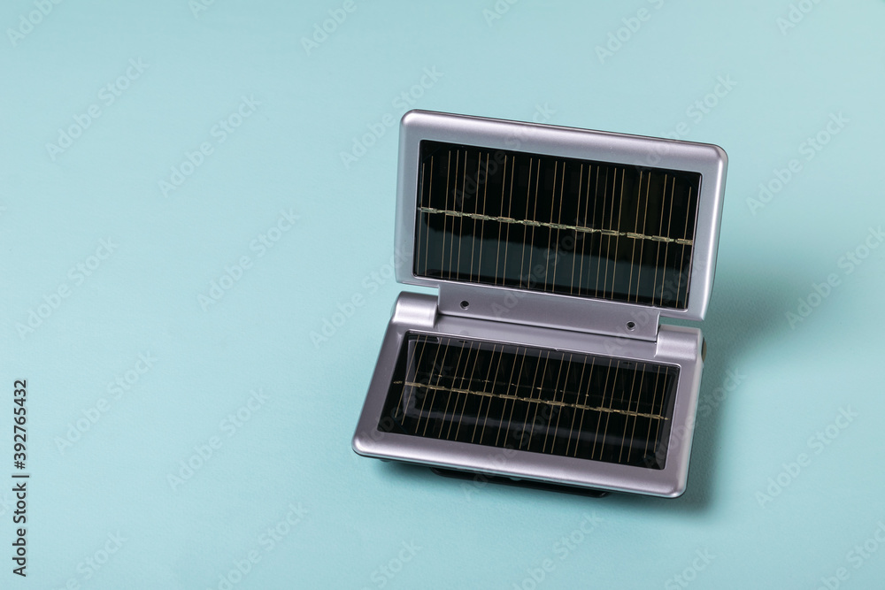 Equipment for charging mobile devices from the energy of sunlight on a blue background. Use of solar energy. Equipment for charging mobile devices from the energy of sunlight on a blue background. Use of solar energy.
