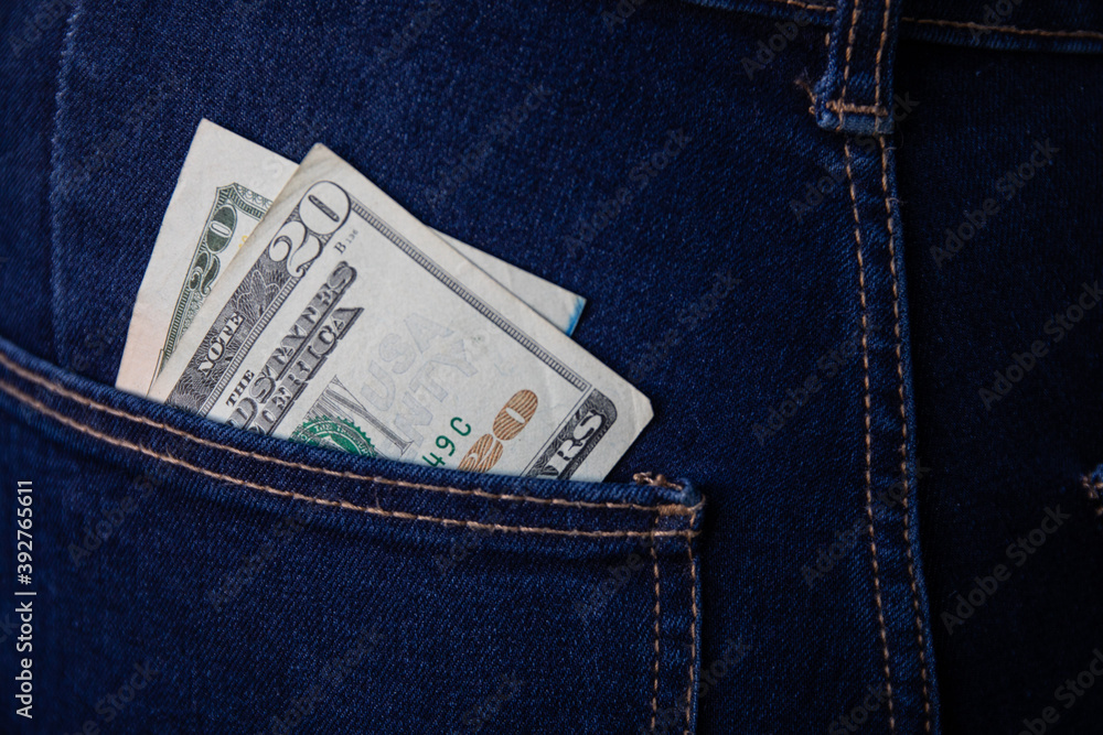 Twenty dollar bill in jean's pocket. Copy space. Close up. Twenty dollar bill in jean's pocket. Copy space. Close up.
