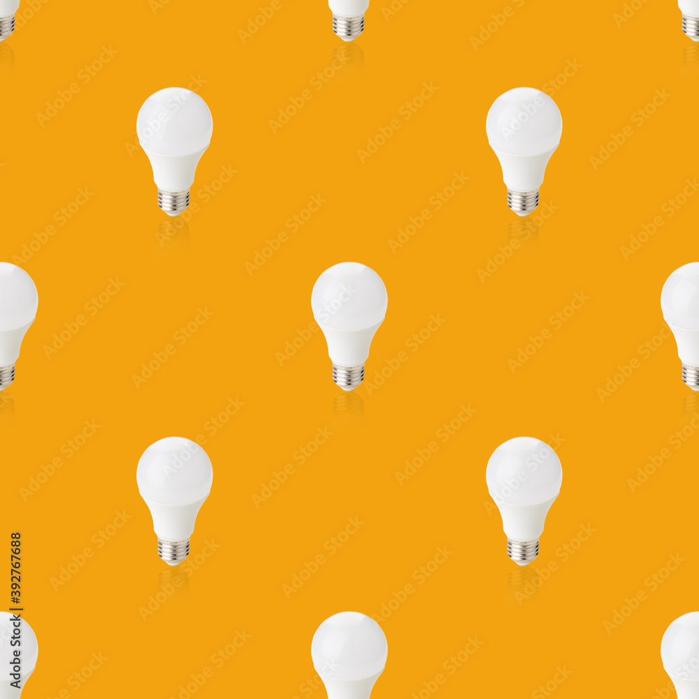 seamless pattern led light bulbs isolated on a orange background. studio shot. idea and creativity symbol seamless pattern led light bulbs isolated on a orange background. studio shot. idea and creativity symbol