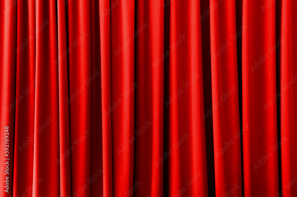 Fotografie Red curtain with light and shadows for texture or background