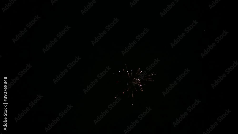 Dark night sky with exploding colourful fireworks in joyful celebration Dark night sky with exploding colourful fireworks in joyful celebration