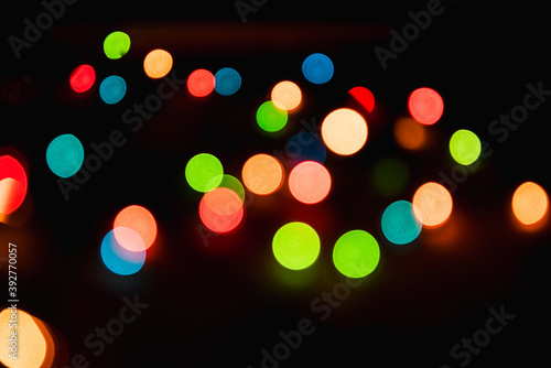 Blurred background. Bright christmas background. Plenty of sparkling bokeh from defocused garland lights. Defocused image.