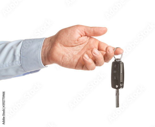 Male hand with car key on white background