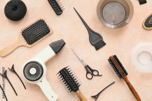 Set of hairdresser tools on color background