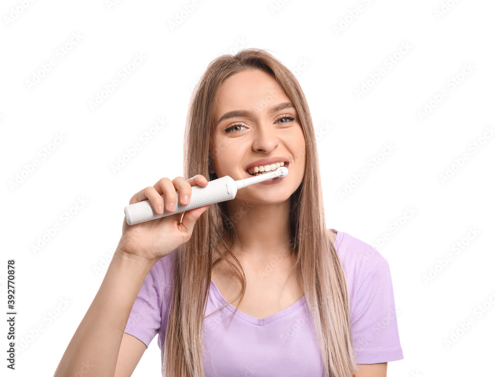 Young woman with electric tooth brush on white background Young woman with electric tooth brush on white background