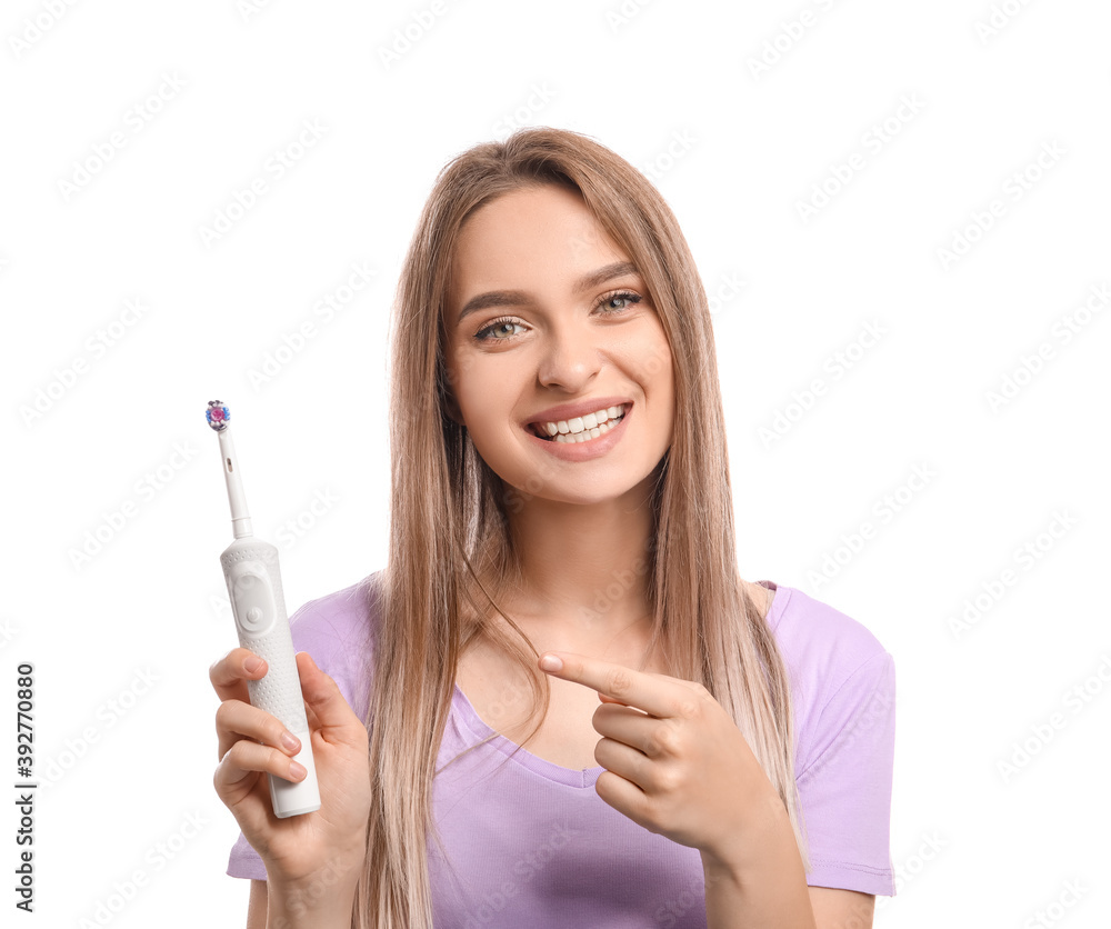 Young woman with electric tooth brush on white background Young woman with electric tooth brush on white background