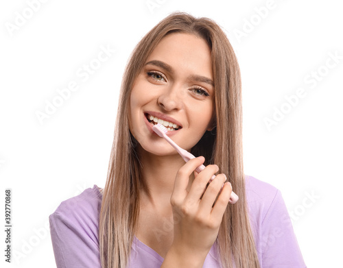Young woman with tooth brush on white background