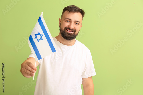 Man with the flag of Israel on color background