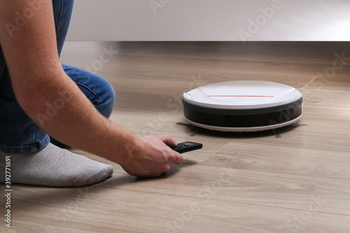 The robot vacuum cleaner cleans under the bed.
