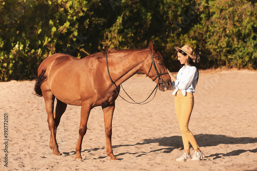 Beautiful young woman with cute horse outdoors © Pixel-Shot