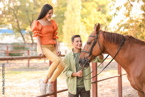 Young couple with cute hors...
