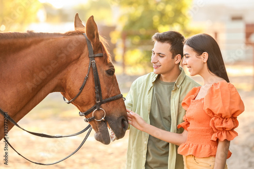 Young couple with cute hors...