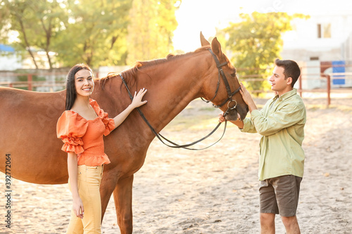 Young couple with cute hors...