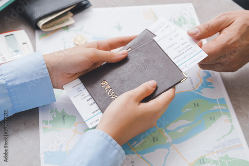 Travel agent giving client documents for future trip in office