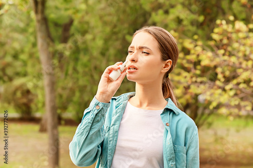 Allergic young woman using ...