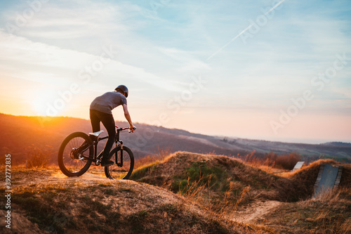 a mountain biker riding a bike through the hills © kerkezz
