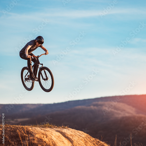 Young man flying through the air on a mountain bike © kerkezz
