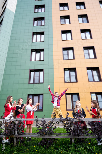 Wallpaper Mural Group of fun children in stylish clothes near big modern house in the city Torontodigital.ca