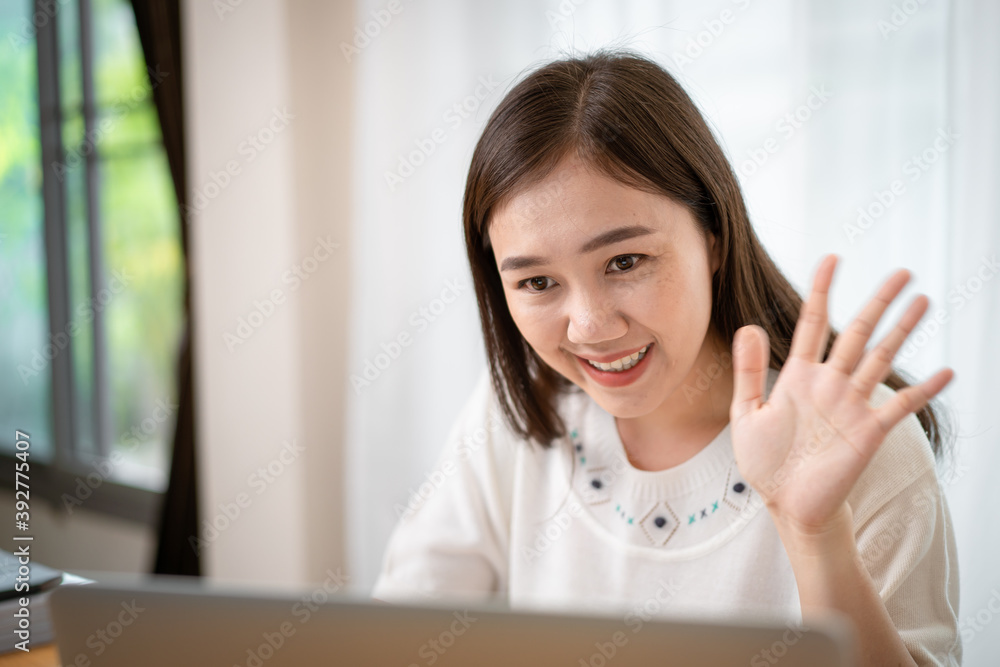 Happy Asian happy woman using her personal laptop computer for working and making a video conference Happy Asian happy woman using her personal laptop computer for working and making a video conference
