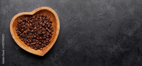 Roasted coffee beans in heart shaped bowl