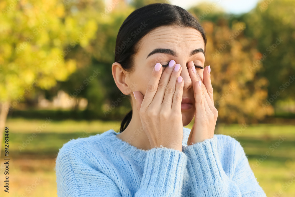 Young woman suffering from allergy outdoors - obrazy, fototapety, plakaty 