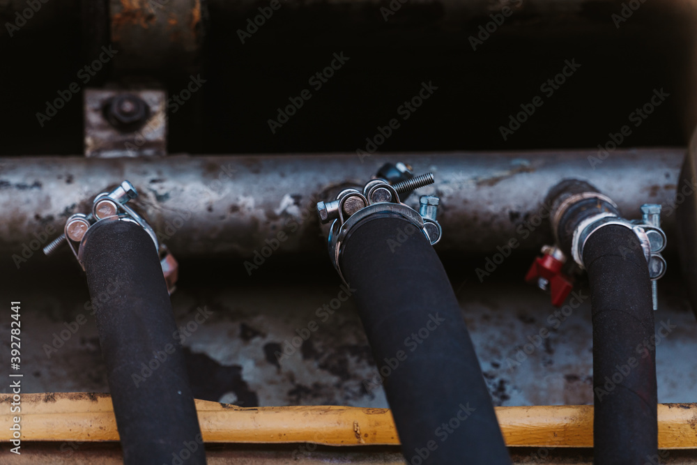 Black rubber hoses leading to the pipe Black rubber hoses leading to the pipe