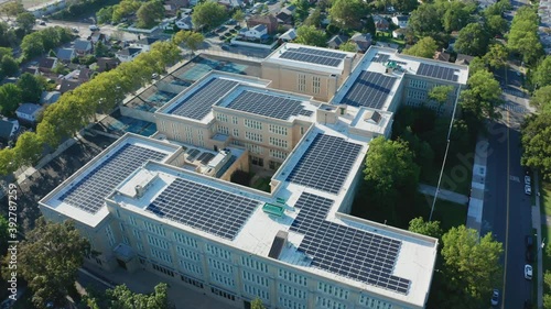 Aerial Drone Shot Orbiting a Large PV Solar Installation on Bayside High School