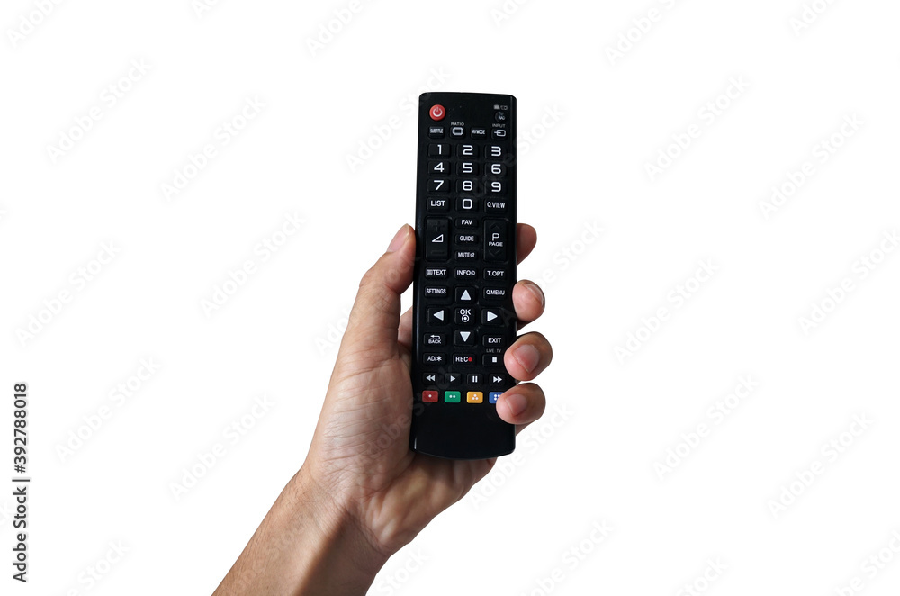 A hand holding a television remote control on a white background. Thumb is pressing a button on the remote.