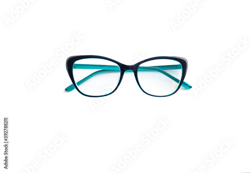 Eye problem. Green glasses with transparent lenses in the frame, for reading in everyday life for a visually impaired person. White background as the background of the health concept with space to cop