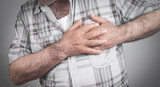 Man holding his chest suffering from heart attack.