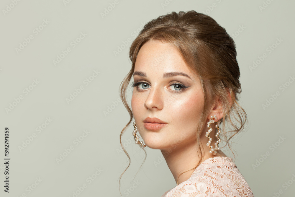 Pretty woman face. Nice woman with ginger hair and pastel color makeup on white background. Pretty woman face. Nice woman with ginger hair and pastel color makeup on white background.