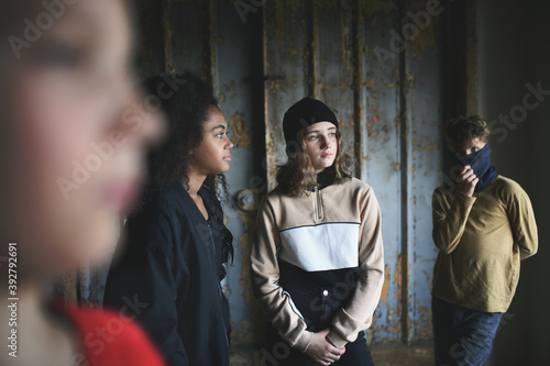 Foto Group of teenagers gang standing indoors in abandoned building, bullying concept