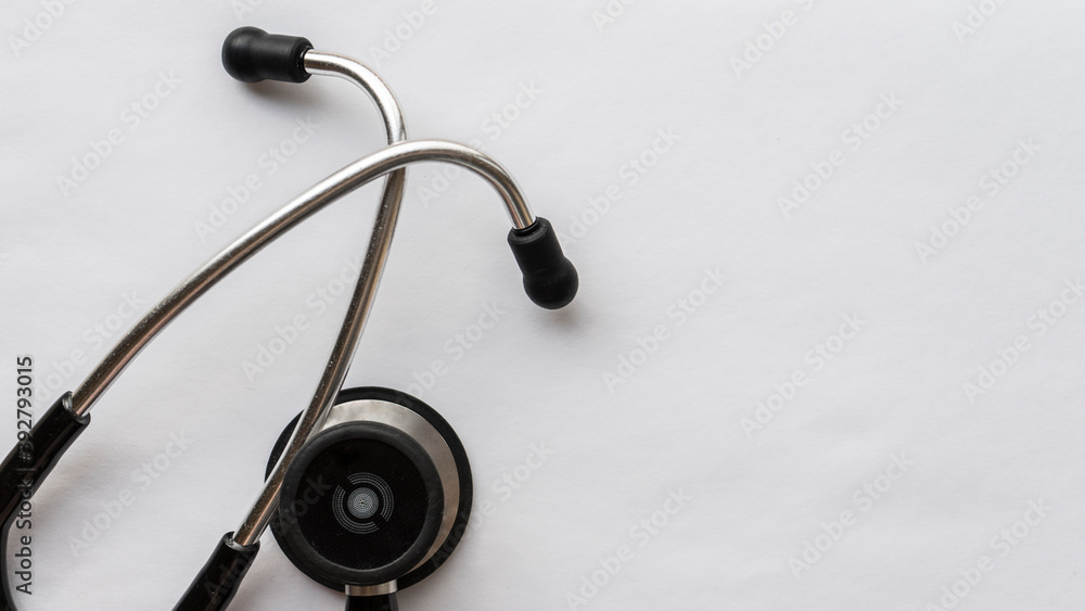 Medical cardiology stethoscope in silver color with black ear pads and tubes on a white background Medical cardiology stethoscope in silver color with black ear pads and tubes on a white background