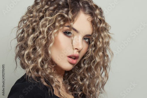 Nice woman with curly hairstyle on white background portrait