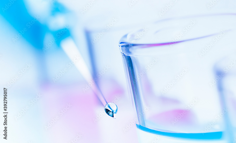 a drop of liquid on the syringe needle and test tubes in a row. double exposure a drop of liquid on the syringe needle and test tubes in a row. double exposure