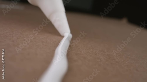 A person applies PVA glue to the surface. Close-up.