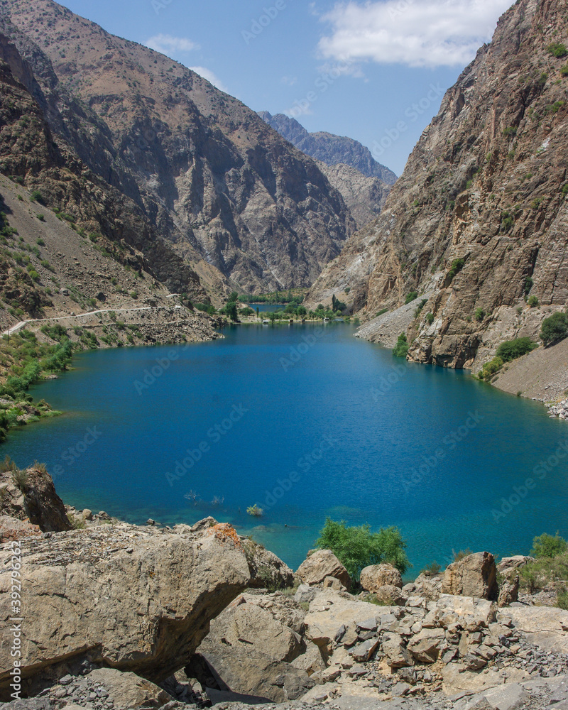 Turquoise blue Gushor lake in scenic mountain landscape in the Marguzor seven lakes area, Shing river valley, Fann mountains, near Penjikent or Panjakent in Tajikistan